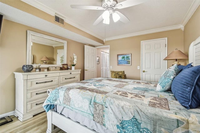 bedroom with crown molding, light hardwood / wood-style floors, and ceiling fan