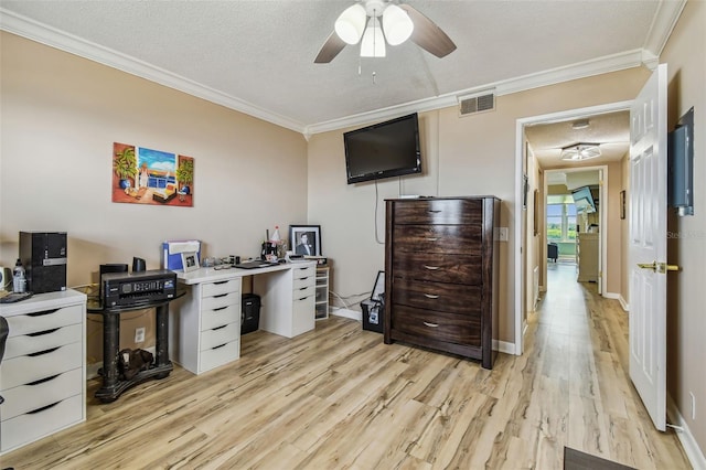 office space with light wood-type flooring, a textured ceiling, ceiling fan, and crown molding