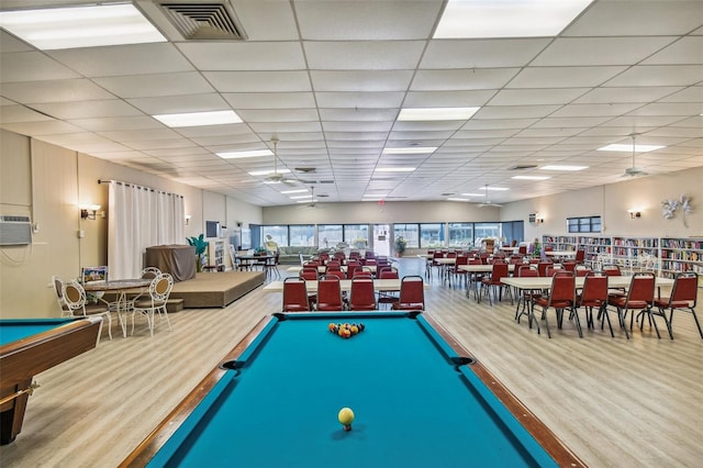 playroom featuring a paneled ceiling and hardwood / wood-style floors