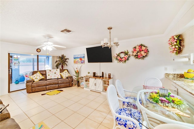 living room with light tile patterned floors, ceiling fan with notable chandelier, and crown molding