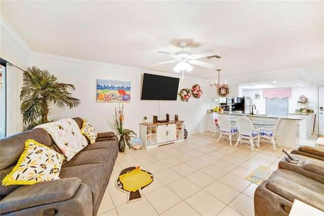 living room with sink, crown molding, ceiling fan, light tile patterned floors, and a textured ceiling