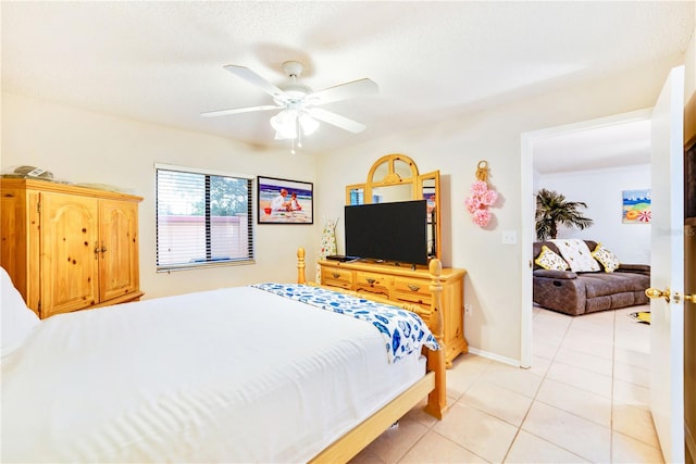 tiled bedroom with ceiling fan and a textured ceiling