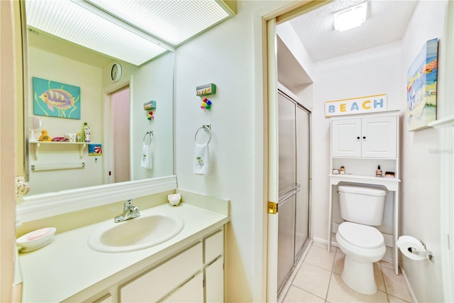 bathroom with tile patterned floors, walk in shower, vanity, and toilet