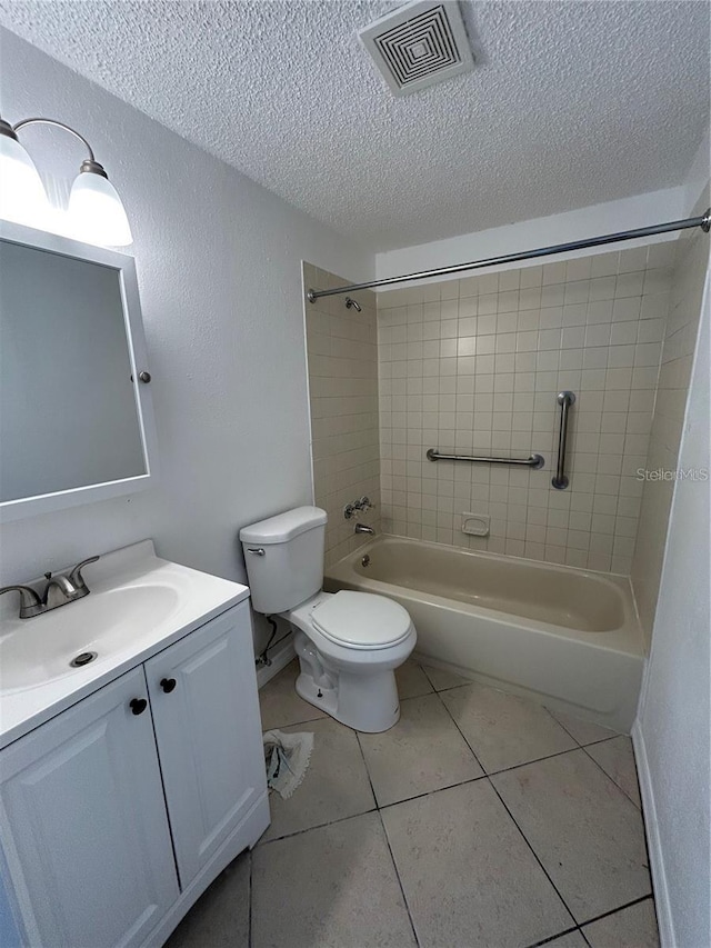 bathroom with a textured ceiling, toilet, visible vents, tile patterned floors, and washtub / shower combination