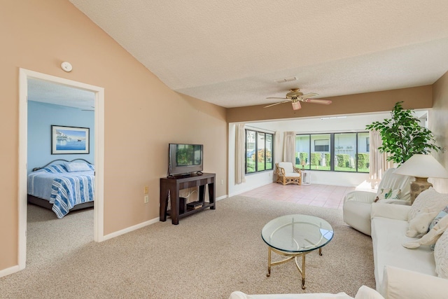 living room featuring light carpet, a textured ceiling, vaulted ceiling, and ceiling fan