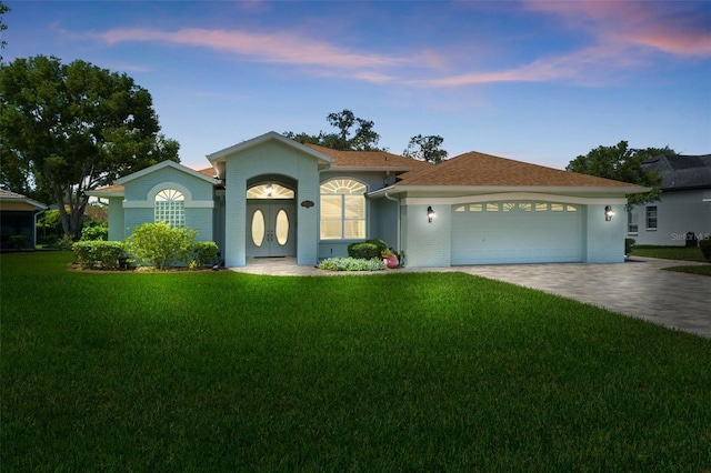 view of front of house with a lawn and a garage