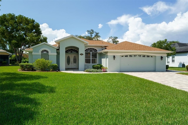 view of front of home with a garage and a front lawn