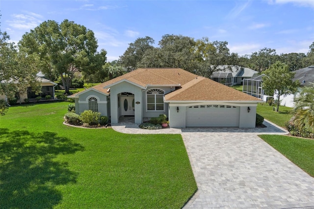 view of front of house featuring a front lawn and a garage