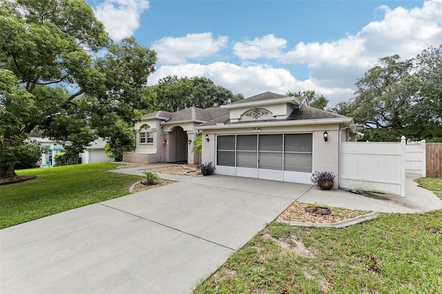 view of front of property featuring a garage and a front lawn