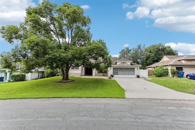 view of front of property with a front lawn and a garage