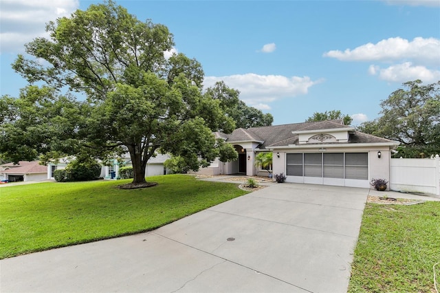 single story home with a garage and a front lawn