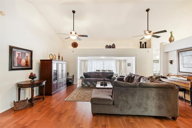 living room with ceiling fan, dark wood-type flooring, and high vaulted ceiling