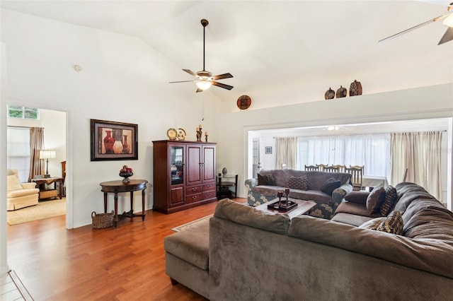 living room with ceiling fan, dark hardwood / wood-style floors, and high vaulted ceiling