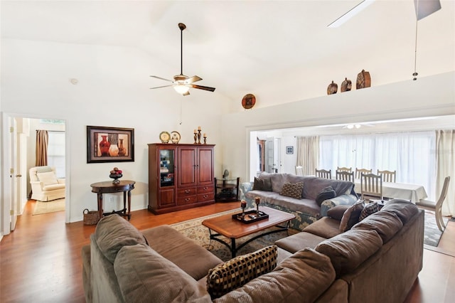 living room with light wood-type flooring, ceiling fan, and high vaulted ceiling