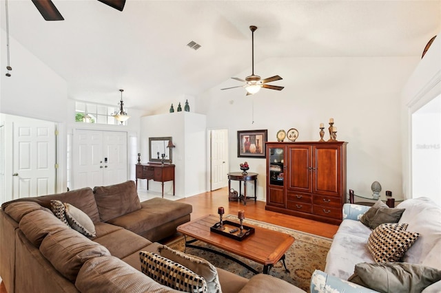 living room featuring ceiling fan, light hardwood / wood-style flooring, and high vaulted ceiling