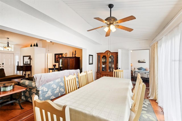 dining space featuring ceiling fan, lofted ceiling, and light hardwood / wood-style floors