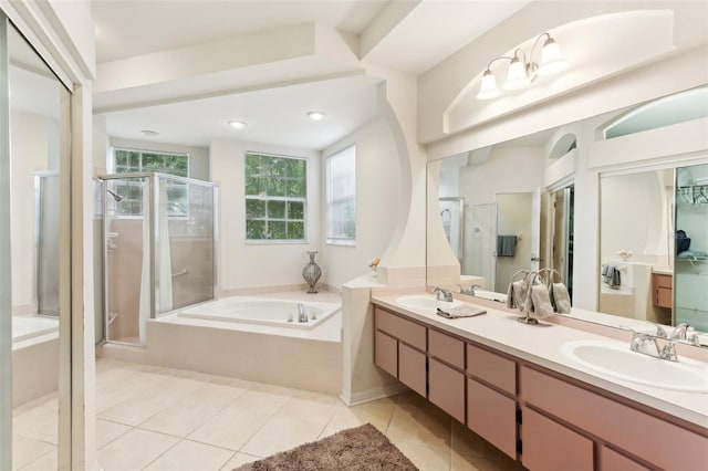 bathroom with shower with separate bathtub, tile patterned floors, plenty of natural light, and vanity