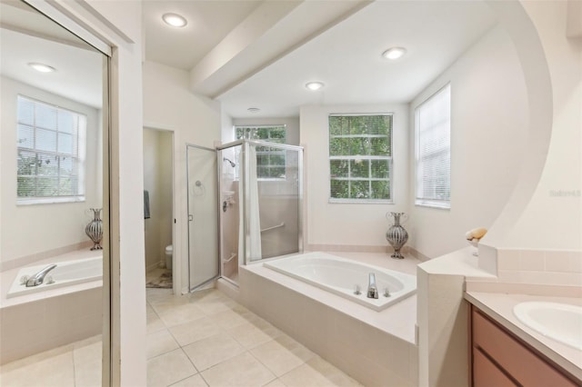 full bathroom featuring independent shower and bath, vanity, toilet, and tile patterned floors