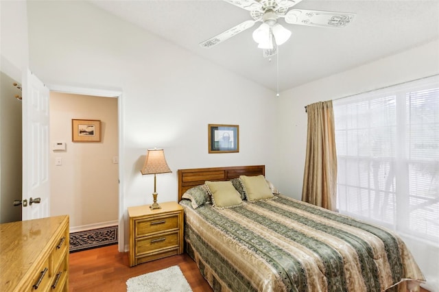 bedroom with ceiling fan and dark wood-type flooring