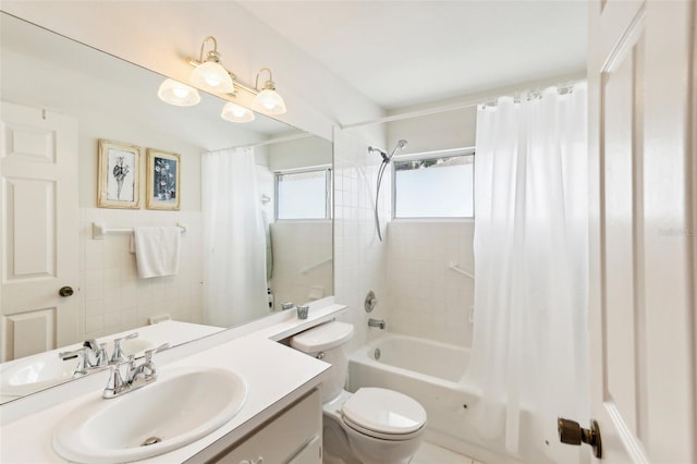 full bathroom featuring shower / bath combo with shower curtain, vanity, and toilet