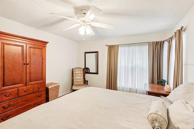 bedroom with a textured ceiling and ceiling fan