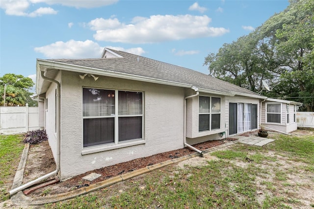 rear view of property with a yard