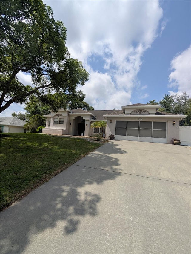 8088 Spanish Oak Dr, Spring Hill, FL 34606 - view of front of home with a garage, driveway, and a front yard