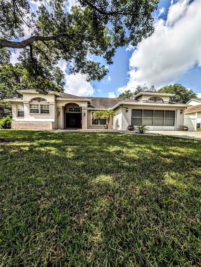 8088 Spanish Oak Dr, Spring Hill, FL 34606 - view of front of house featuring a front lawn, stucco siding, and a garage
