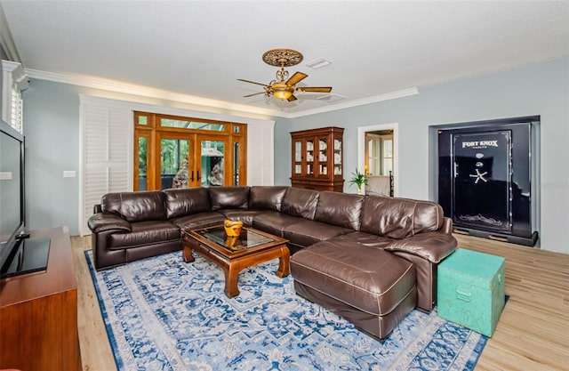 living room featuring french doors, crown molding, wood-type flooring, and ceiling fan