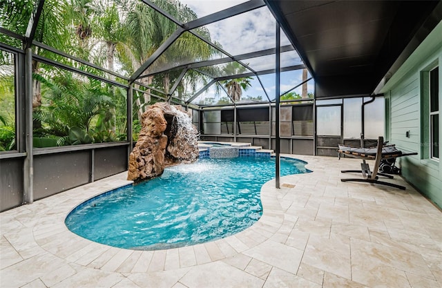 view of swimming pool featuring an in ground hot tub, pool water feature, a patio, and glass enclosure