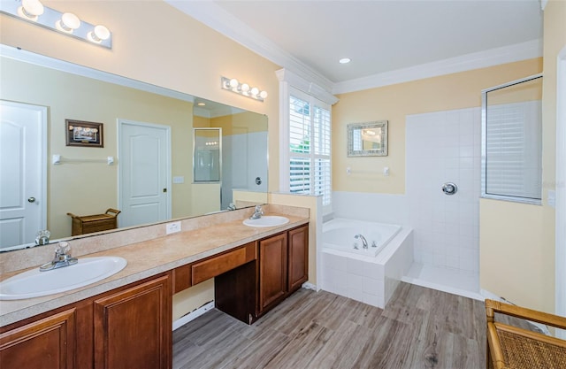 bathroom featuring independent shower and bath, ornamental molding, and wood-type flooring