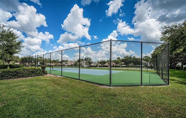 view of sport court with a yard