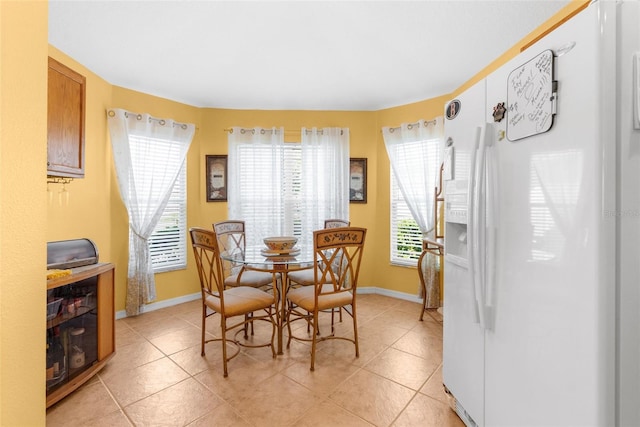 dining area featuring light tile patterned floors