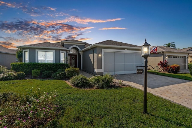 view of front of property with a lawn and a garage