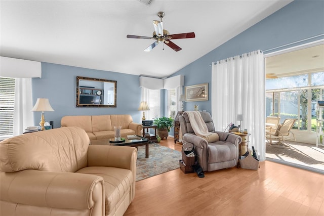 living room featuring ceiling fan, vaulted ceiling, and light hardwood / wood-style flooring