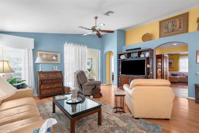 living room featuring a wealth of natural light, light hardwood / wood-style flooring, ceiling fan, and lofted ceiling