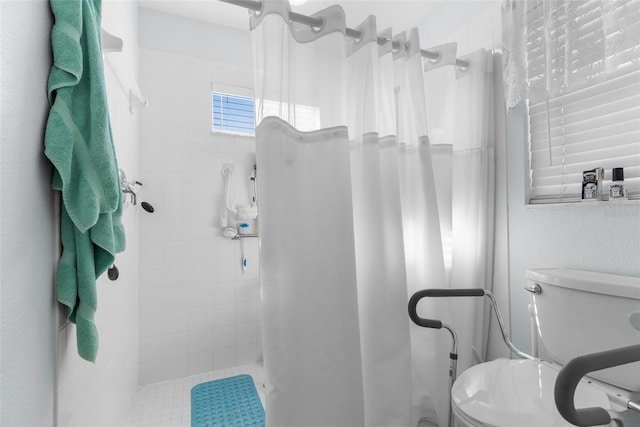 bathroom with toilet and curtained shower