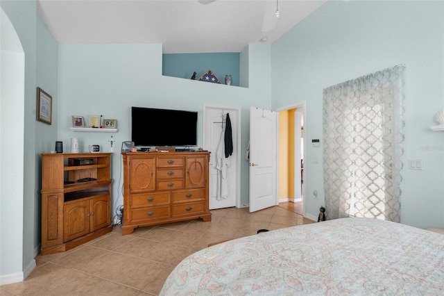 tiled bedroom with high vaulted ceiling