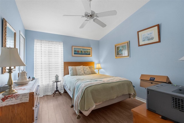 bedroom featuring hardwood / wood-style flooring, ceiling fan, and lofted ceiling