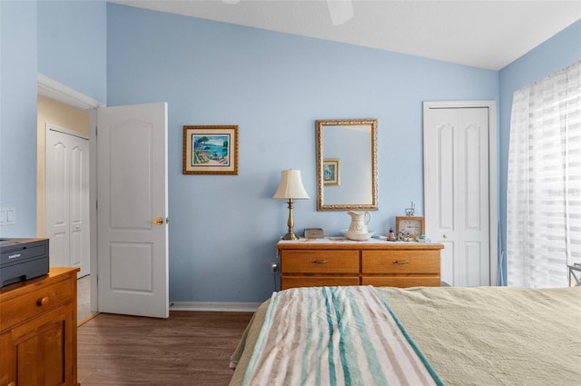 bedroom featuring ceiling fan, dark hardwood / wood-style flooring, and vaulted ceiling