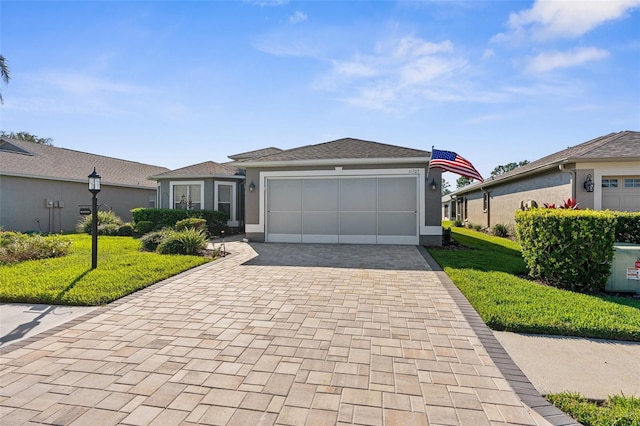 ranch-style home featuring a garage and a front lawn