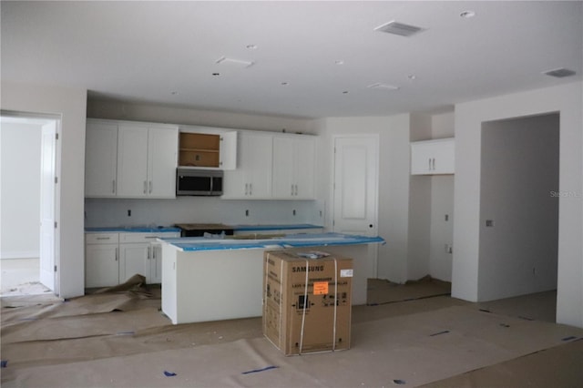 kitchen featuring white cabinets and a kitchen island