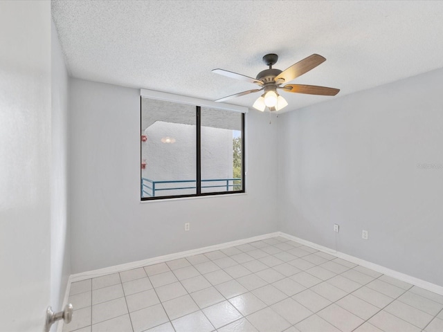 unfurnished room with light tile patterned flooring, ceiling fan, and a textured ceiling