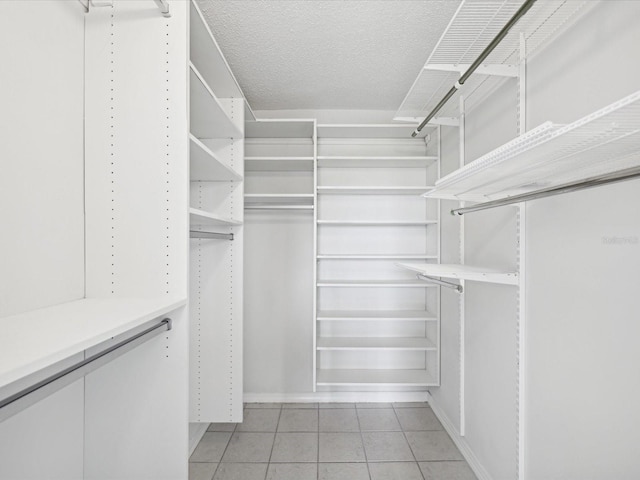 spacious closet featuring light tile patterned floors