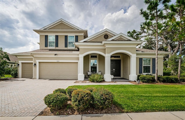 view of front of house with a front lawn and a garage