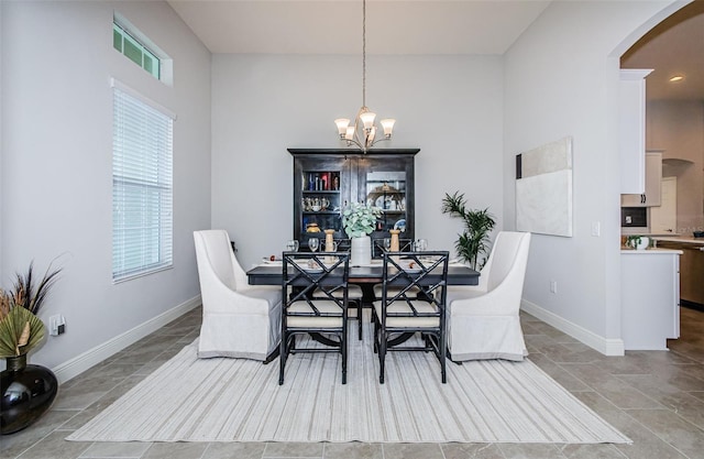 dining area with an inviting chandelier