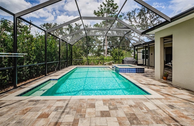 view of swimming pool featuring a lanai, an in ground hot tub, and a patio