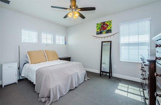 carpeted bedroom with ceiling fan and multiple windows