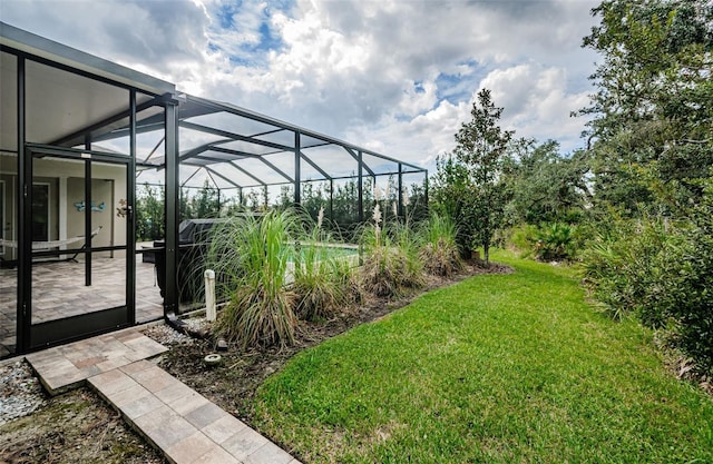 view of yard with a patio area and a lanai