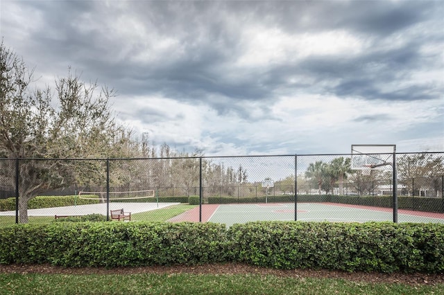 view of tennis court featuring basketball hoop